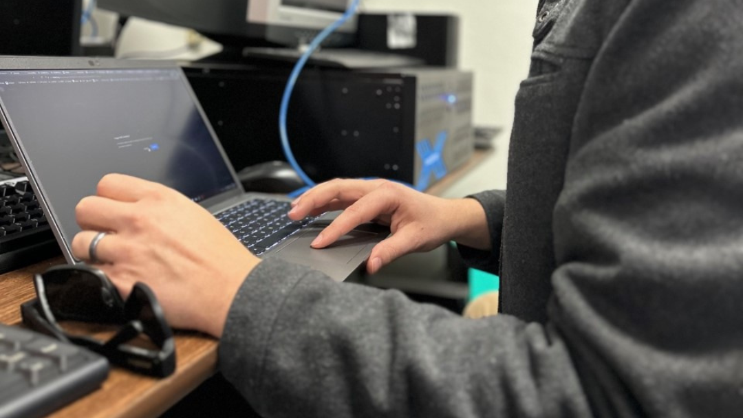 Business professional using a laptop for custom technology solutions